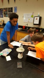 Chance Upshaw, Jonathan Waldrep, and Dusty Smith find the density of unknown liquids during a physical science lab. 