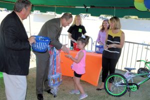 Superintendent Mark Albertus congratulates the winner of a pogo stick.