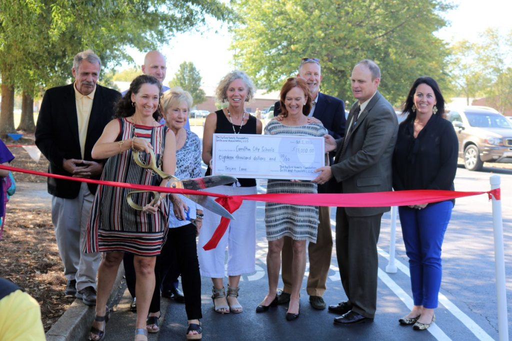 Carrollton Mayor Walt Hollingsworth, Andrea Chapman, David Godwin, Linda Fulford, Kristi Garrett, Robyn Grillo, John Grillo, Carrollton City Schools Superintendent Mark Albertus and Katie Williams are shown at a ribbon cutting ceremony for the new "Trojan Lane" - a new bike and pedestrian path in front of Carrollton Elementary School. The new lane was made possible by donations from the Fulford Family Foundation and Grillo and Associates LLC.