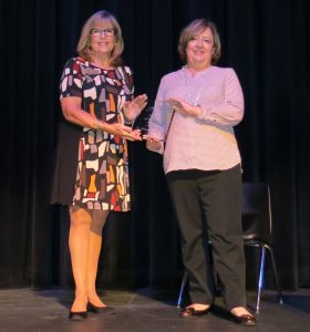 Dr. Melanie McClellan, right, accepts 2016 Woman of the Year award from Paula Gillispie, the 2015 award winner.