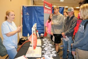 Phyllis Head, community liaison at Get Healthy, Live Well, shows Bremen High School students the consequences using tobacco — from yellow teeth to lung and oral cancers.